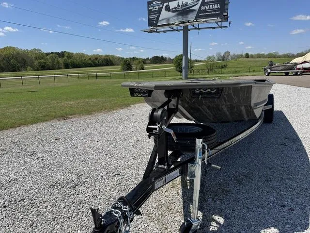 Slide: The Image of War Eagle 754 LDV boat on trailer, parked on gravel, under clear blue sky. - 4