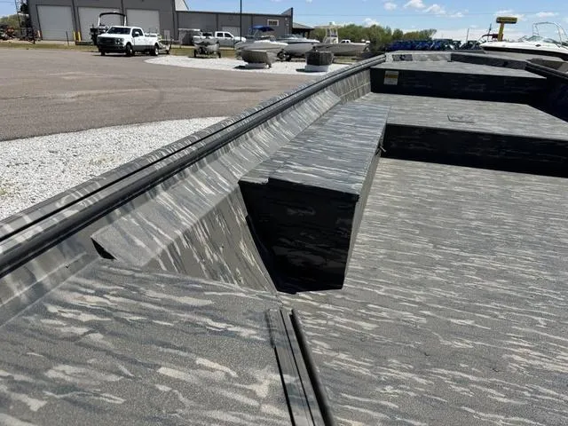 Slide: The Image of 2025 War Eagle 754 LDV boat interior with camouflage pattern, parked outdoors. - 6