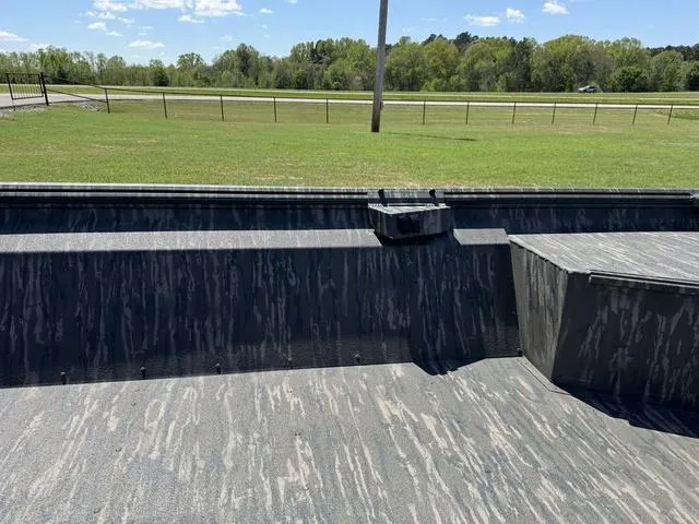 Slide: The Image of Interior of 2025 War Eagle 754 LDV boat with camouflage pattern, grassy field background. - 7