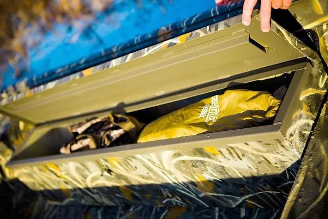 Slide: The Image of Open storage compartment in War Eagle 648LDV 21" boat, 2025 model, with gear inside. - 4