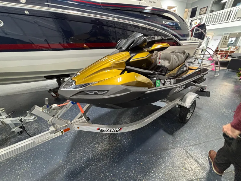 Slide: The Image of 2023 Kawasaki ULTRA 160LX jet ski on trailer in showroom. - 11