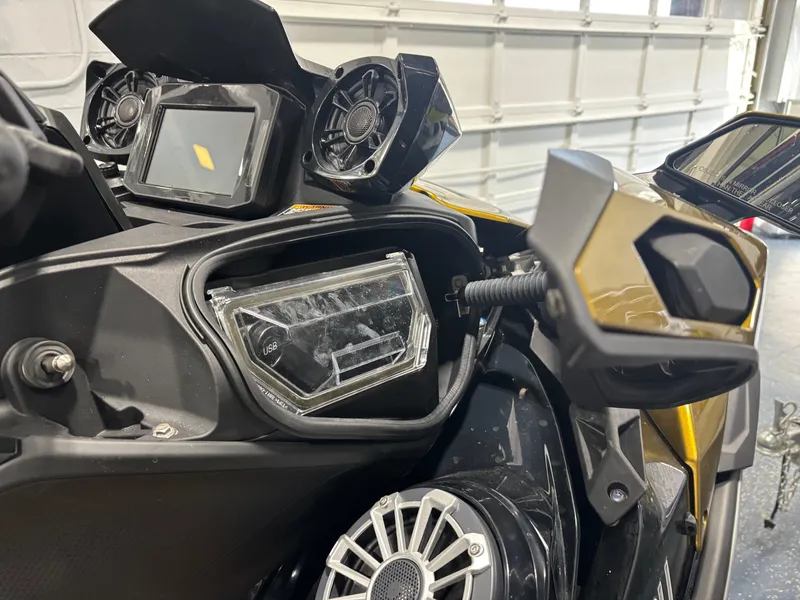 Slide: The Image of 2023 Kawasaki ULTRA 160LX dashboard with mirrors and controls in a garage setting. - 4