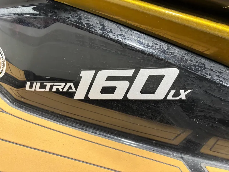 Slide: The Image of 2023 Kawasaki ULTRA 160LX logo on a sleek black and gold surface. - 6