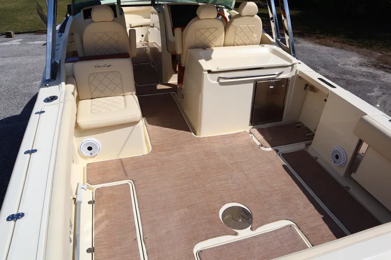 Slide: The Image of 2020 Chris-Craft Calypso 30 boat interior with beige seating and spacious deck. - 14