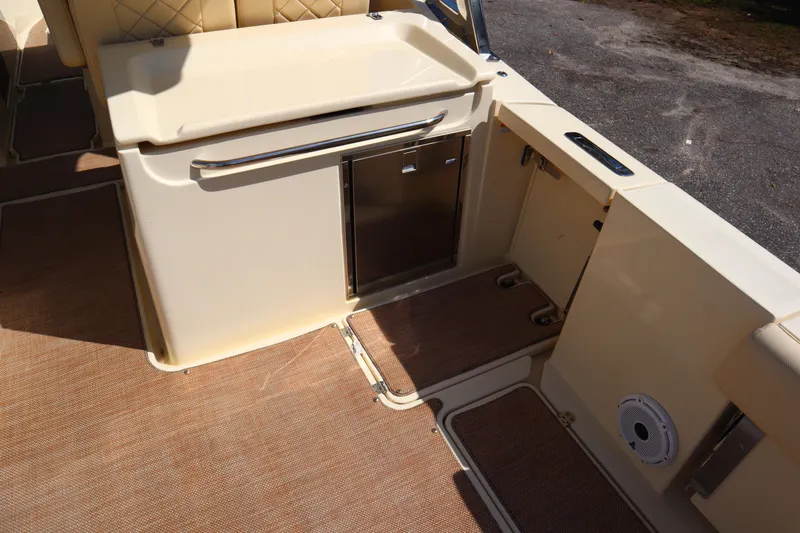 Slide: The Image of 2020 Chris-Craft Calypso 30 boat interior with storage compartments and cushioned seating. - 17