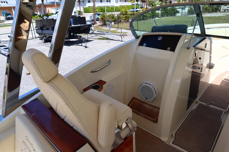 Slide: The Image of 2020 Chris-Craft Calypso 30 interior with beige seating and modern dashboard. - 20