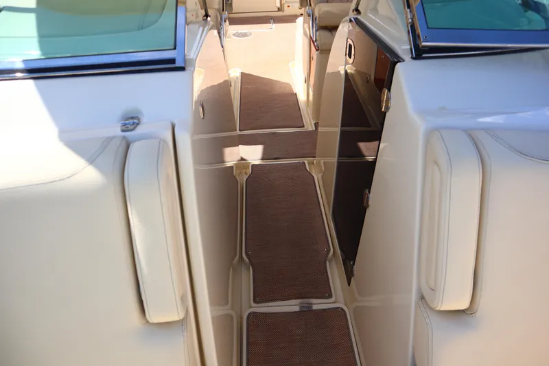 Slide: The Image of 2020 Chris-Craft Calypso 30 interior with beige seating and brown flooring. - 28