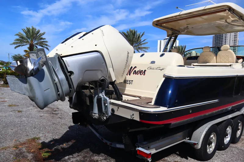 Slide: The Image of 2020 Chris-Craft Calypso 30 boat on trailer, featuring powerful outboard motor. - 35