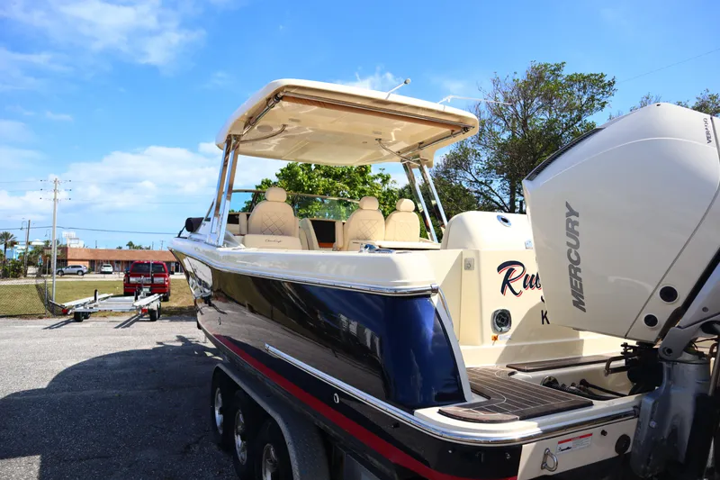 Slide: The Image of 2020 Chris-Craft Calypso 30 boat with Mercury engine, parked on a trailer. - 5