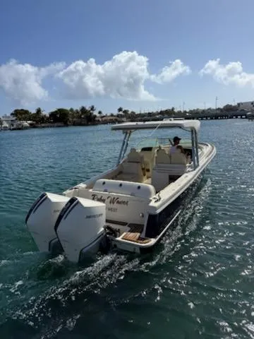 Slide: The Image of 2020 Chris-Craft Calypso 30 boat cruising on clear blue water under a sunny sky. - 7