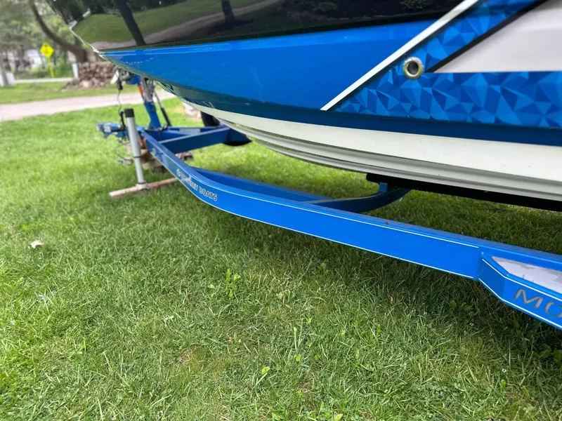 Slide: The Image of 2017 Monterey M6 boat on blue trailer, parked on grass. - 10