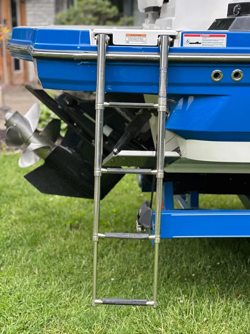 Slide: The Image of 2017 Monterey M6 boat with a stainless steel swim ladder on grass. - 12