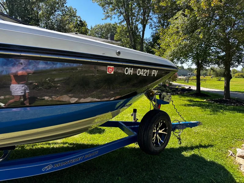 Slide: The Image of 2017 Monterey M6 boat on trailer, parked on grass, sunny day. - 14