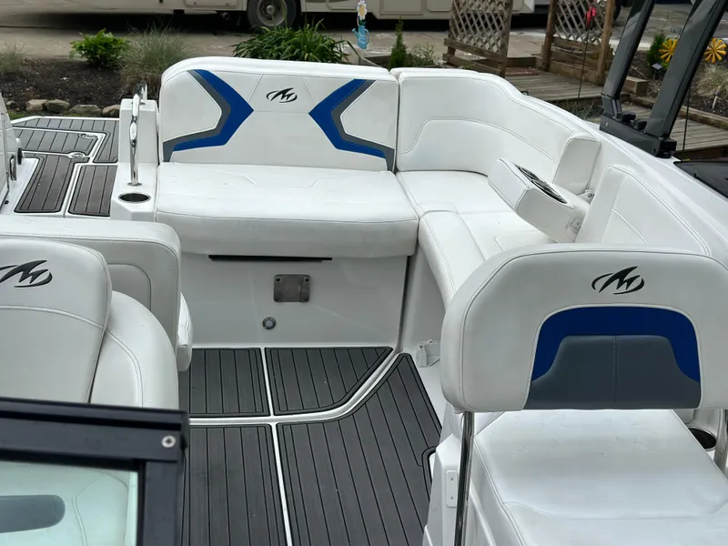 Slide: The Image of 2017 Monterey M6 boat interior with white and blue seating, sleek design, and modern features. - 24