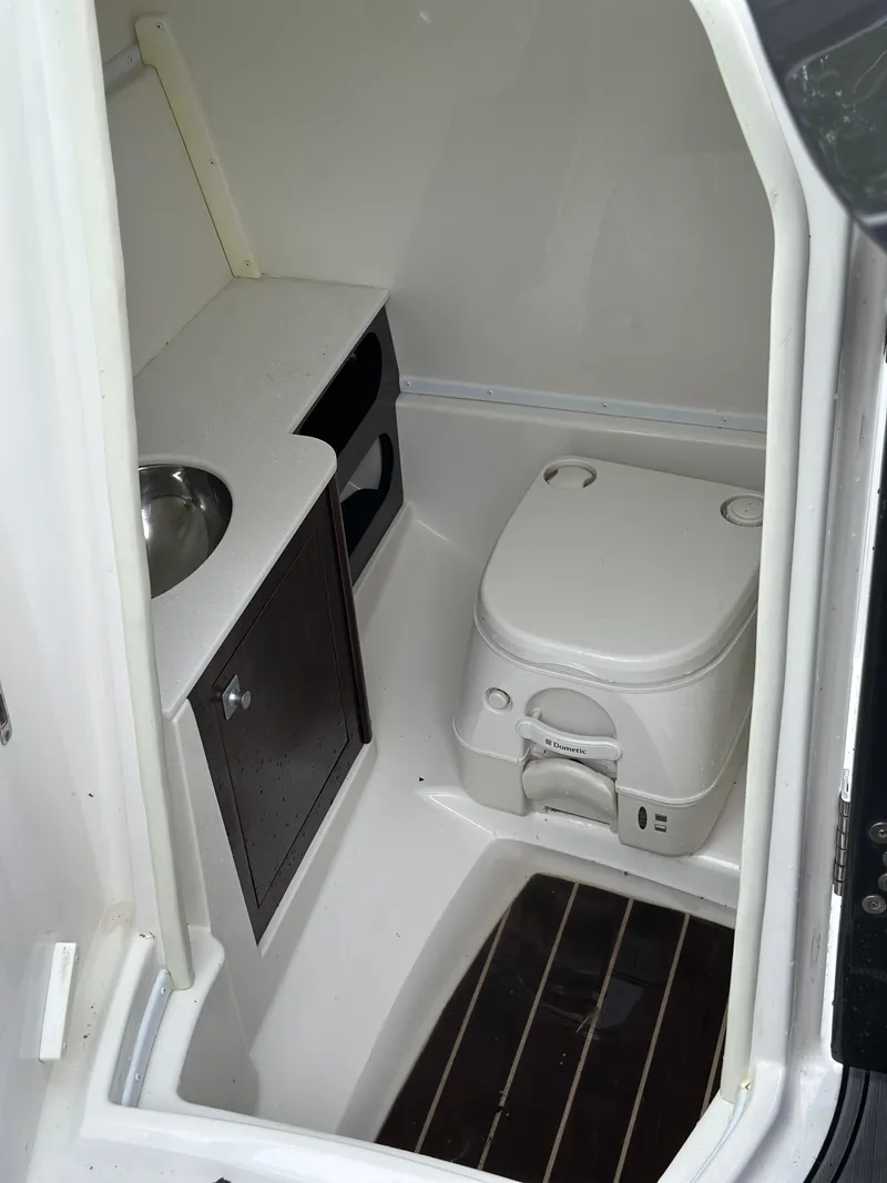 Slide: The Image of 2017 Monterey M6 boat bathroom with compact toilet and sink. - 27