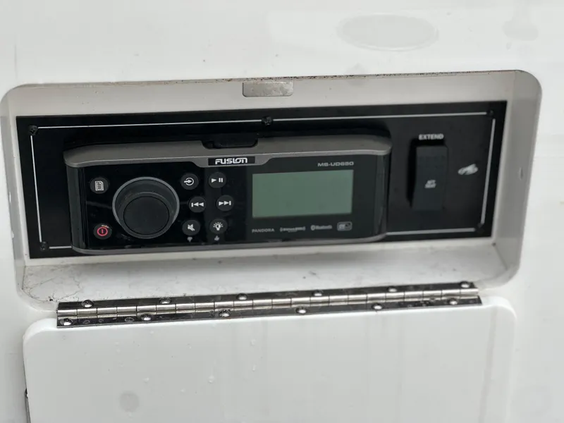Slide: The Image of Control panel of a 2017 Monterey M6 boat featuring a Fusion MS-UD650 stereo system. - 28