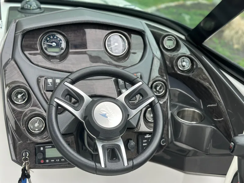 Slide: The Image of Steering wheel and dashboard of a 2017 Monterey M6 boat, featuring gauges and controls. - 29