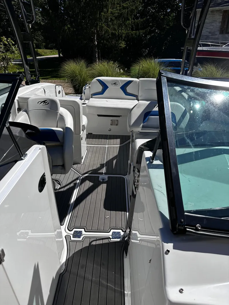 Slide: The Image of 2017 Monterey M6 boat interior with seating and windshield, docked outdoors. - 32