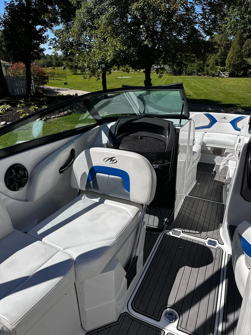 Slide: The Image of 2017 Monterey M6 boat interior with white and blue seating, sleek design, and spacious layout. - 33