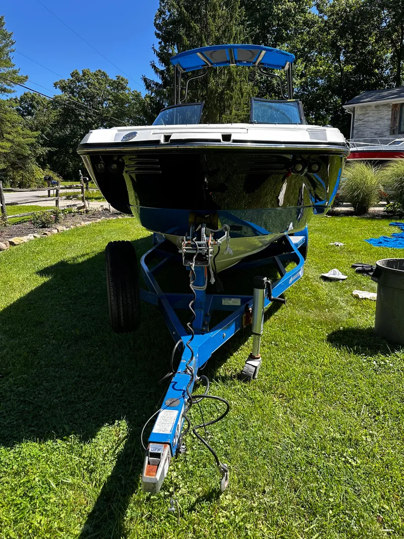 Slide: The Image of 2017 Monterey M6 boat on trailer, parked on grass, surrounded by trees and a house. - 36