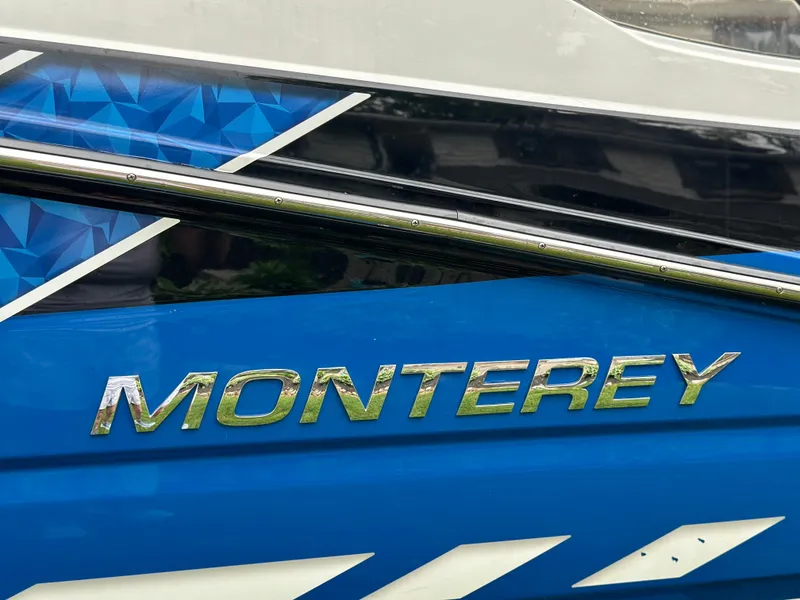 Slide: The Image of 2017 Monterey M6 boat with blue geometric design and chrome logo. - 5