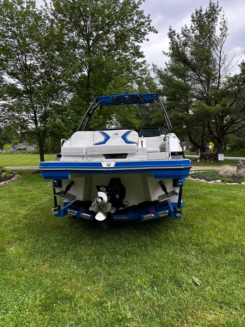 Slide: The Image of 2017 Monterey M6 boat on grass, surrounded by trees, viewed from the rear. - 8