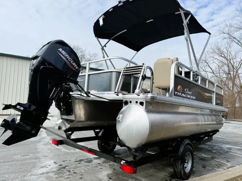 Slide: The Image of 2025 Sun Tracker Party Barge 18 DLX pontoon boat with Mercury outboard motor. - 2