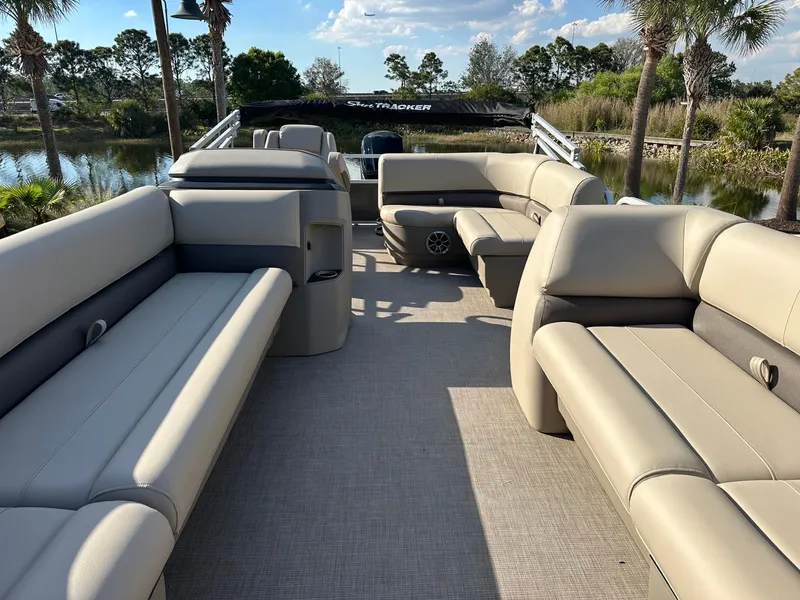 Slide: The Image of 2025 Sun Tracker Party Barge 18 DLX interior with spacious seating and scenic lake view. - 5