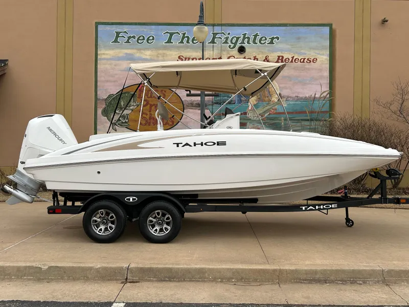 The Image of 2025 Tahoe 2150 CC boat on trailer, parked outdoors, side view. - 0