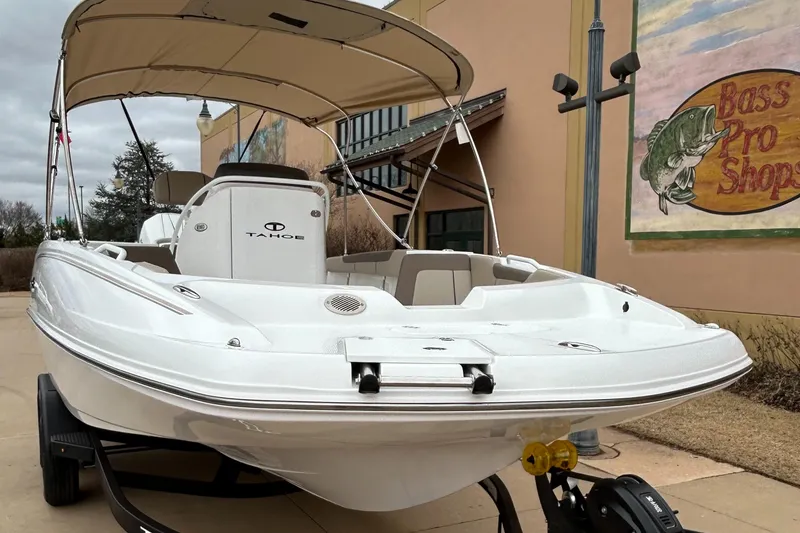 Slide: The Image of 2025 Tahoe 2150 CC boat displayed outside Bass Pro Shops. - 2