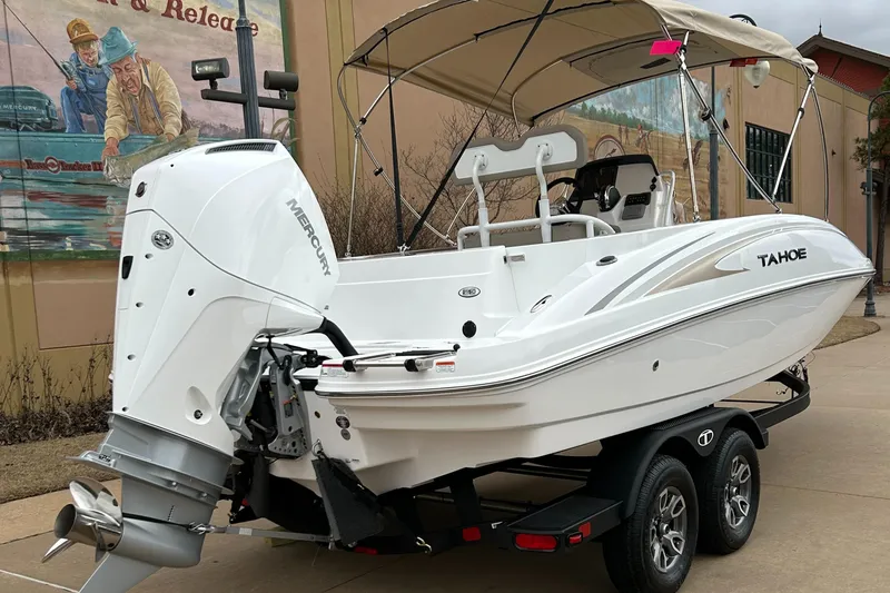 Slide: The Image of 2025 Tahoe 2150 CC boat with Mercury outboard engine on a trailer. - 3