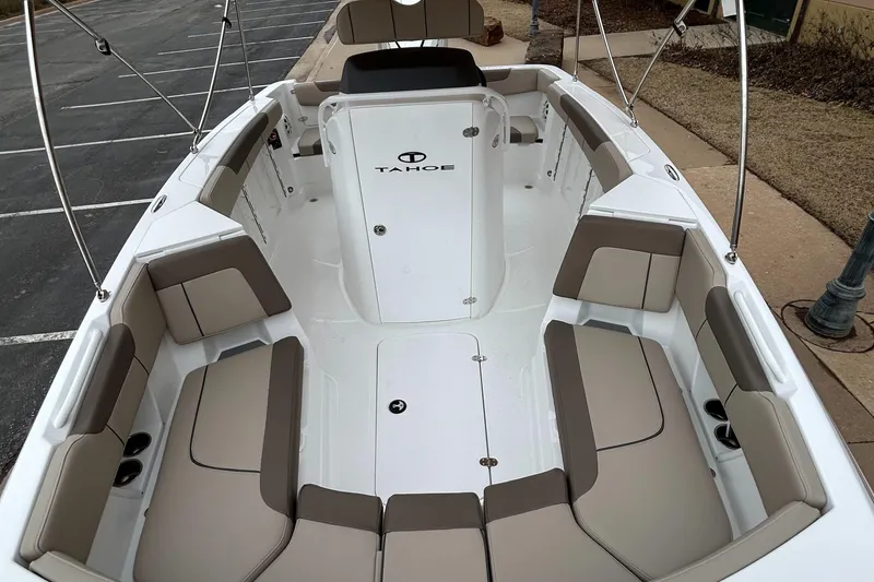 Slide: The Image of 2025 Tahoe 2150 CC boat interior with beige seating and white deck. - 5