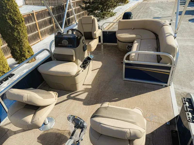 Slide: The Image of 2025 Sun Tracker Bass Buggy 16 XL Select pontoon boat interior with beige seating. - 3