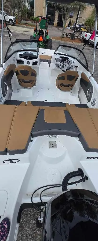 Slide: The Image of 2025 Tahoe 200 S boat interior with tan seating and modern design. - 2