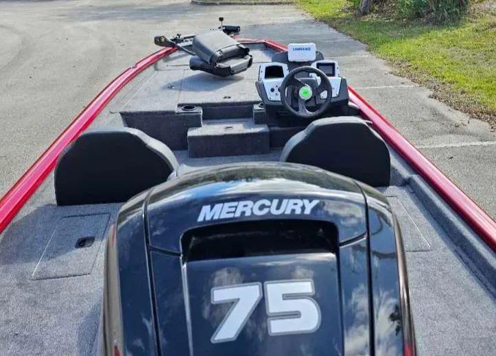 Slide: The Image of 2025 Tracker Pro Team 175 boat with Mercury 75 engine, parked on pavement. - 6