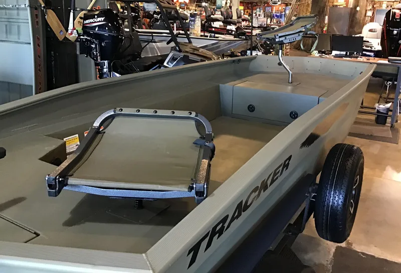 Slide: The Image of 2025 Tracker Grizzly 1650 T Prairie Wings Edition boat in showroom. - 2