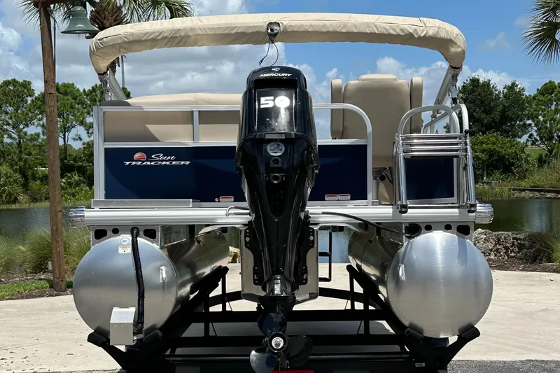 Slide: The Image of 2025 Sun Tracker Bass Buggy 16 XL Select pontoon boat with Mercury 50 engine, rear view. - 3