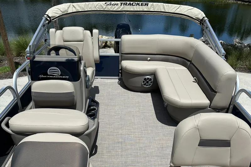Slide: The Image of 2025 Sun Tracker Bass Buggy 16 XL Select pontoon boat with beige seating and spacious deck. - 6