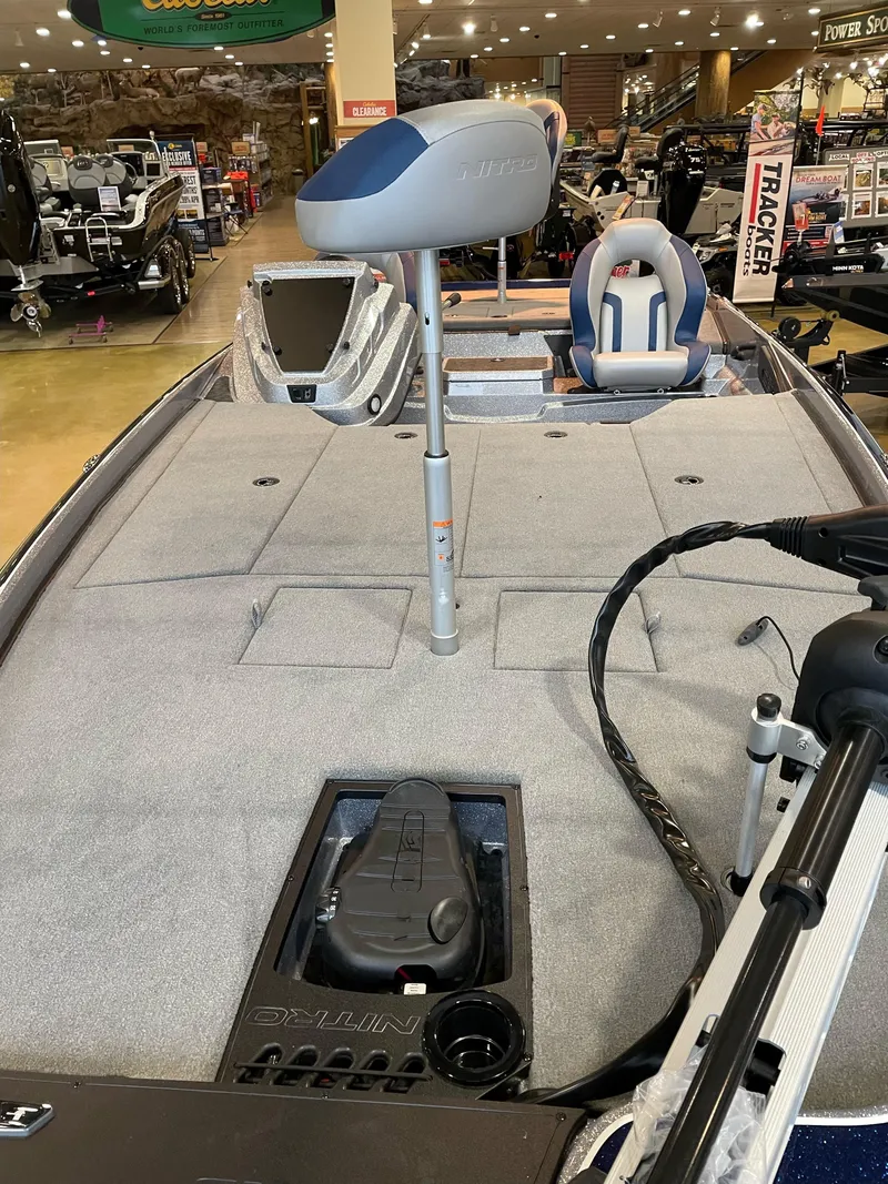 Slide: The Image of 2025 Nitro Z21 XL boat interior with seating and control panel in showroom. - 4