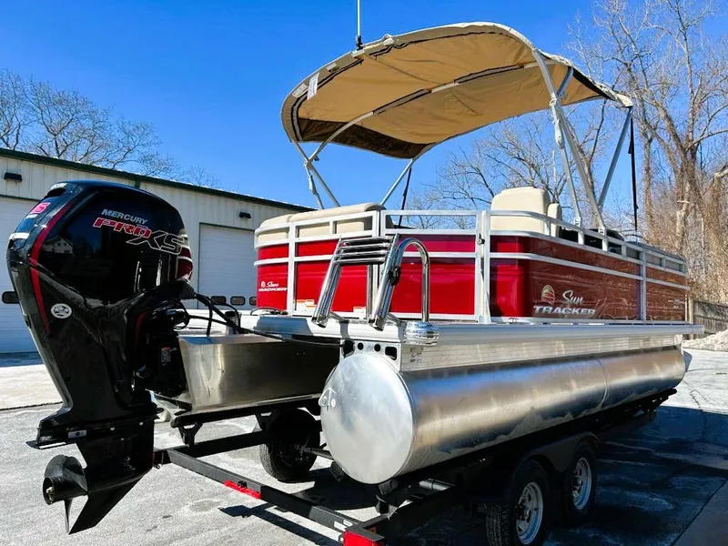 Slide: The Image of 2025 Sun Tracker Party Barge 20 DLX pontoon boat with Mercury outboard motor. - 2