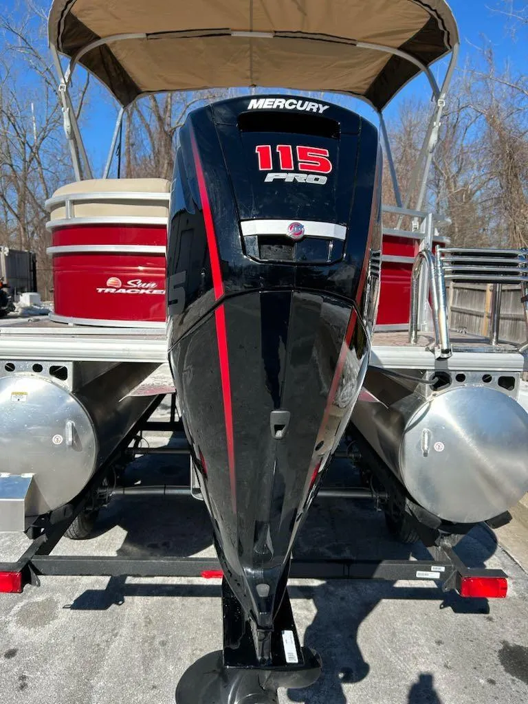 Slide: The Image of 2025 Sun Tracker Party Barge 20 DLX with Mercury 115 engine, docked outdoors. - 4