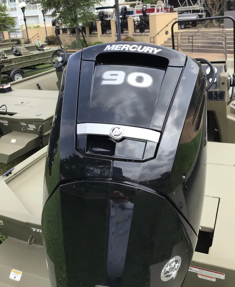 Slide: The Image of 2025 Tracker Grizzly 1860 CC with Mercury 90 engine, outdoor display. - 3