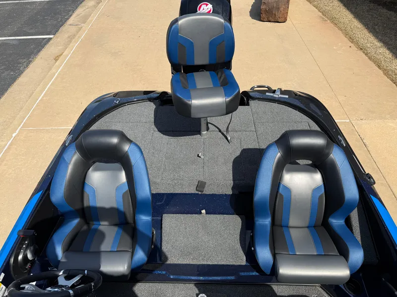 Slide: The Image of 2025 Nitro Z18 boat interior with three blue and gray seats on a carpeted deck. - 5
