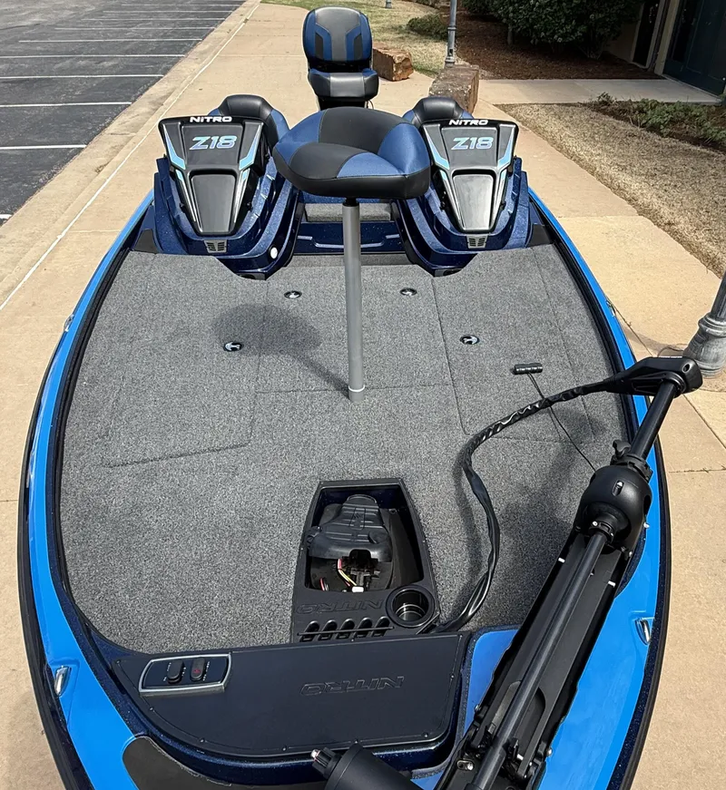 Slide: The Image of 2025 Nitro Z18 boat with dual seats and trolling motor on a blue deck. - 7