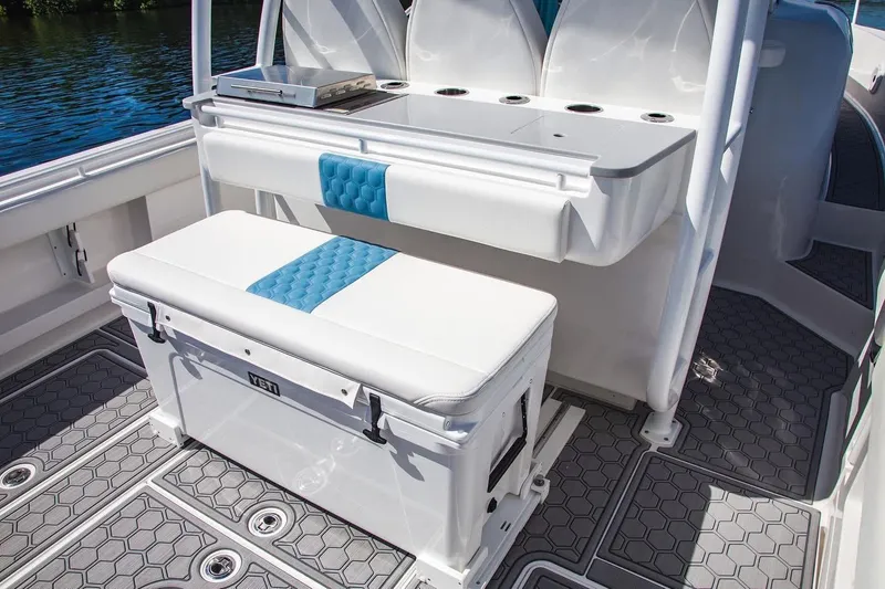 Slide: The Image of 2021 Belzona 32 Walkaround boat interior with cushioned seating and storage. - 5