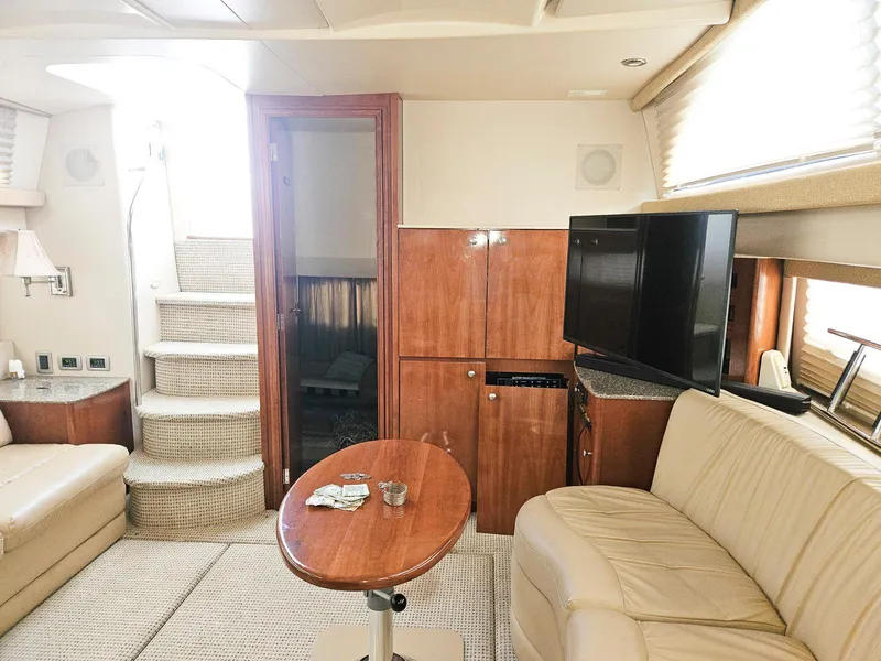 Slide: The Image of Interior of 2005 Meridian 368 Motoryacht with beige seating, wooden cabinetry, and a flat-screen TV. - 11