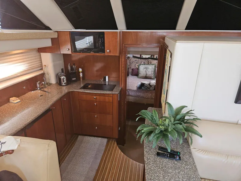 Slide: The Image of 2005 Meridian 368 Motoryacht interior with kitchen, living area, and bedroom view. - 14