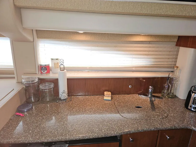 Slide: The Image of 2005 Meridian 368 Motoryacht kitchen with granite countertop and wooden cabinets. - 15