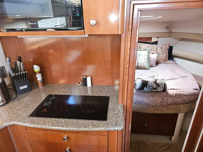 Slide: The Image of 2005 Meridian 368 Motoryacht interior with kitchen and cozy bedroom view. - 17
