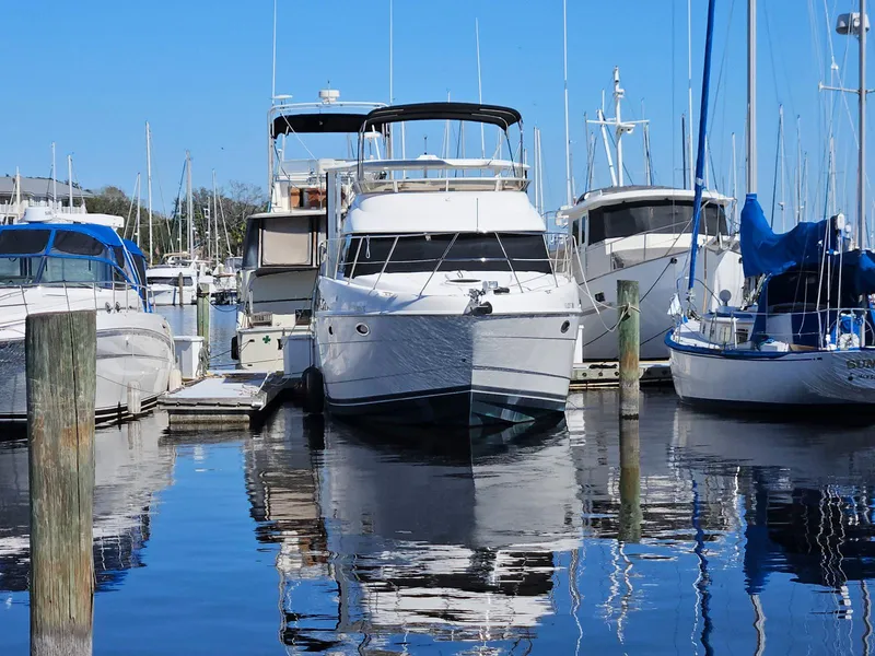 Slide: The Image of 2005 Meridian 368 Motoryacht docked in a marina, surrounded by other boats. - 2